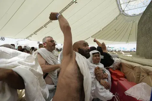 Muslim pilgrims cast stones at pillars in the symbolic stoning of the devil, the last rite of the annual hajj, in Mina, near the holy city of Mecca, Saudi Arabia, Sunday, June 16, 2024. Masses of pilgrims on Sunday embarked on a symbolic stoning of the devil in Saudi Arabia. The ritual marks the final days of the Hajj, or Islamic pilgrimage, and the start of the Eid al-Adha celebrations for Muslims around the world. (AP Photo/Rafiq Maqbool)