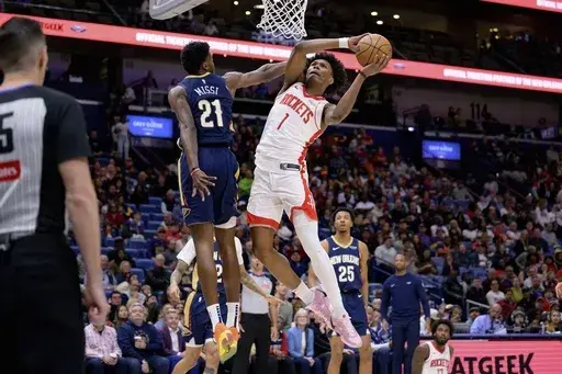 Houston Rockets forward Amen Thompson (1) gets around New Orleans Pelicans center Yves Missi (21) for a basket during the first half of an NBA basketball game in New Orleans, Thursday, March 6, 2025. (AP Photo/Matthew Hinton)