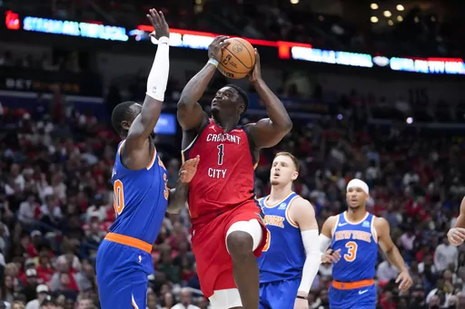 New Orleans Pelicans forward Zion Williamson (1) goes to the basket against New York Knicks forward Julius Randle in the first half of an NBA basketball game in New Orleans, Saturday, Oct. 28, 2023. The Pelicans won 96-87. (AP Photo/Gerald Herbert)