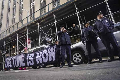 Demonstrators unveil a banner outside Manhattan's district attorney office, supporting a grand jury vote to indict former President Donald Trump, Thursday March 30, 2023, in New York. A Manhattan grand jury has voted to indict Donald Trump on charges involving payments made during the 2016 presidential campaign to silence claims of an extramarital sexual encounter, his lawyers said Thursday, producing the first criminal case against a former U.S. president and a jolt to Trump’s bid to retake t