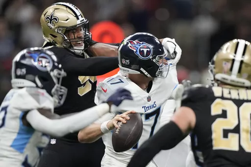 New Orleans Saints defensive end Payton Turner, second from left, pressures Tennessee Titans quarterback Ryan Tannehill (17) in the first half of an NFL football game in New Orleans, Sunday, Sept. 10, 2023. (AP Photo/Gerald Herbert)