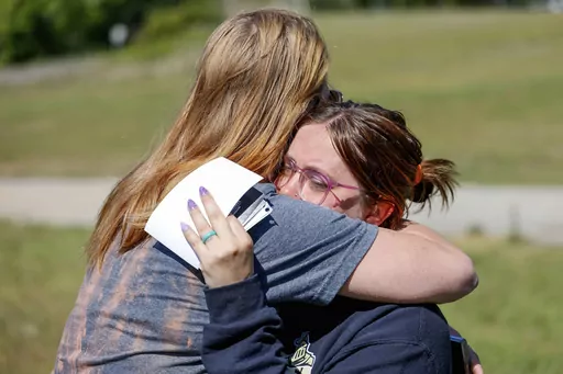 Ashleigh Webster hugs family friend Shannon Dillon at her home in Henryetta, Okla., Tuesday, May 2, 2023. (Nathan J. Fish/The Oklahoman via AP)