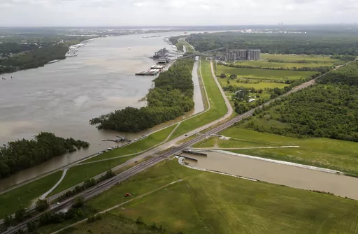 This May 1, 2019, file photo, shows the Davis Pond Diversion, a project that diverts water from the Mississippi River, left, into the Barataria Basin to reduce coastal erosion in St. Charles Parish, La. Officials are breaking ground in southeast Louisiana on a nearly $3 billion project to fight coastal wetland loss. It involves building massive gates in a section of levee in a rural area southeast of New Orleans and creating a channel to divert some of the Mississippi River’s sediment-laden wa