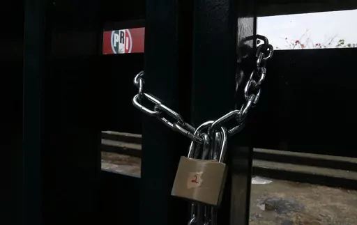 The doors of the headquarters of Mexico's Institutional Revolutionary Party, PRI, remain closed with chains in Mexico City, Wednesday, June 30, 2021. The PRI has been reduced to a shadow of its former self by the rise of President Andrés Manuel López Obrador's Morena party, which won the governorship of the last major PRI bastion, the State of Mexico, on June 2023. (AP Photo/Marco Ugarte, File)