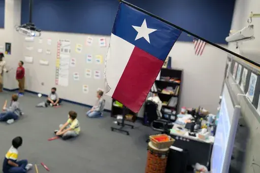 A Texas flag is displayed in an elementary school in Murphy, Texas, Thursday, Dec. 3, 2020. (AP Photo/LM Otero, File)