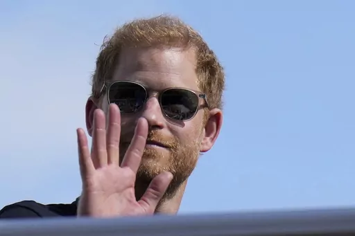 Britain's Prince Harry, The Duke of Sussex, waves during the Formula One U.S. Grand Prix auto race at Circuit of the Americas, on Oct. 22, 2023, in Austin, Texas. Prince Harry was not improperly stripped of his publicly funded security detail during visits to Britain after he gave up his status as a working member of the royal family and moved to the U.S., a London judge ruled Wednesday Feb. 28, 2024. (AP Photo/Nick Didlick, File)