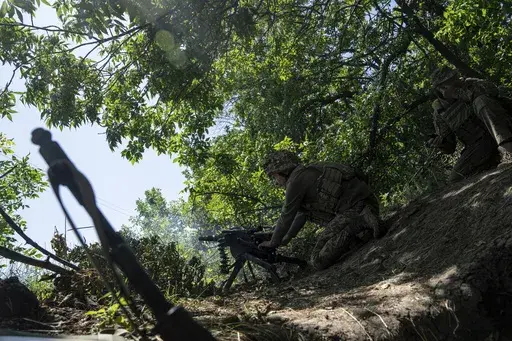 A Ukrainian marine of 35th brigade fires by automatic grenade launcher AGS-17 towards Russian positions on the outskirts of Avdiivka, Ukraine, on June 19, 2023. Ukrainian troops are under intense pressure from a determined Russian effort to storm the strategically important eastern Ukraine city of Avdiivka, officials say. Kyiv’s army is struggling with ammunition shortages as the Kremlin’s forces pursue a battlefield triumph around the two-year anniversary of Moscow’s full-scale invasion a