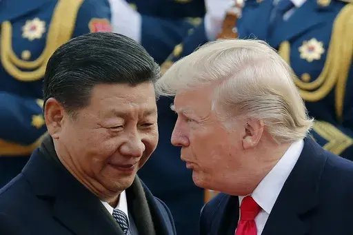 U.S. President Donald Trump, right, chats with Chinese President Xi Jinping during a welcome ceremony at the Great Hall of the People in Beijing on Nov. 9, 2017. (AP Photo/Andy Wong, File)