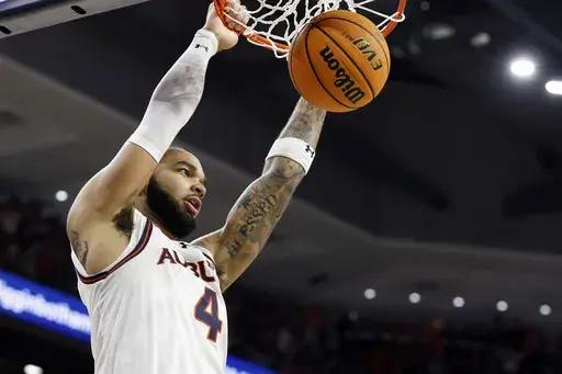 Auburn forward Johni Broome dunks during the second half of an NCAA college basketball game against Alabama, Saturday, March 8, 2025, in Auburn, Ala. (AP Photo/Butch Dill)