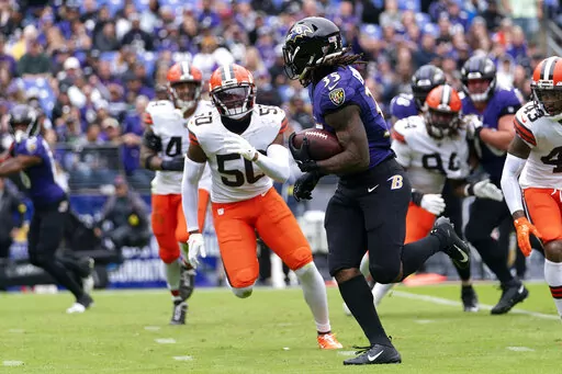 Cleveland Browns linebacker Jacob Phillips (50) chases after Baltimore Ravens running back Gus Edwards (35), who scored on the running play, during the first half of an NFL football game, Sunday, Oct. 23, 2022, in Baltimore. The Ravens won 23-20. (AP Photo/Julio Cortez)