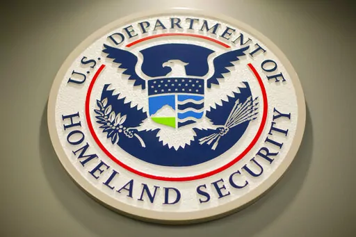 Homeland Security logo is seen during a joint news conference in Washington, Feb. 25, 2015. Nina Jankowicz, the former head of a widely criticized disinformation board, faced a torrent of sexist profanities on social media and menacing emails filled with rape or death threats. And she is not alone as women around the globe who have risen to powerful government positions have faced an overwhelming crush of online harassment, stalking and abuse. (AP Photo/Pablo Martinez Monsivais, File)