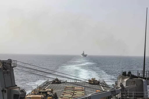 In this image provided by the U.S. Navy, the amphibious dock landing ship USS Carter Hall and amphibious assault ship USS Bataan transit the Bab al-Mandeb strait on Aug. 9, 2023. The top commander of U.S. naval forces in the Middle East says Yemen’s Houthi rebels are showing no signs of ending their “reckless” attacks on commercial ships in the Red Sea. But Vice Adm. Brad Cooper said in an Associated Press interview on Saturday that more nations are joining the international maritime missi