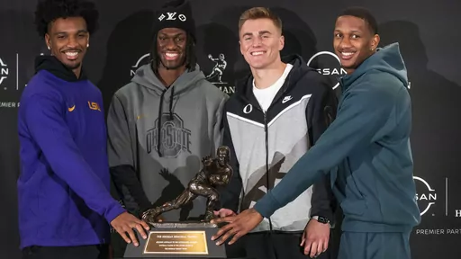 Heisman Trophy finalists, from left, LSU quarterback Jayden Daniels, Ohio State wide receiver Marvin Harrison Jr., Oregon quarterback Bo Nix and Washington quarterback Michael Penix Jr. pose for a photo with the Heisman Trophy, Friday, Dec. 8, 2023, in New York. The Heisman Trophy will be announced Saturday, Dec. 9. (AP Photo/Eduardo Munoz Alvarez)