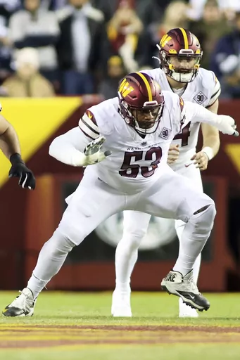Washington Commanders guard Trai Turner (53) blocks during an NFL football game against the Dallas Cowboys, Sunday, Jan. 8, 2023 in Landover. The New Orleans Saints have brought back former tight end Jimmy Graham and also agreed to contract terms with guard Trai Turner. The moves came Tuesday, July 25, 2023, as veterans reported for the club's training camp at team headquarters. (AP Photo/Daniel Kucin Jr.)