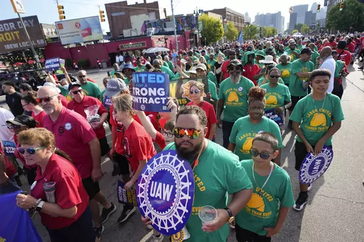 United Auto Workers members walk in the Labor Day parade in Detroit on Sept. 4, 2023. The union is threatening to strike any automaker that hasn't reached an agreement by the time contracts expire on Sept. 14. (AP Photo/Paul Sancya, File)