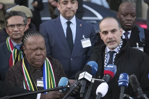 Accompanied with South Africa's Foreign Minister Naledi Pandor, left, Palestinian assistant Minister of Multilateral Affairs Ammar Hijazi addresses reporters after session of the International Court of Justice, or World Court, in The Hague, Netherlands, Friday, Jan. 26, 2024. The United Nations' top court has stopped short of ordering a cease-fire in Gaza in a genocide case but demanded that Israel try to contain death and damage in its military offensive in the tiny coastal enclave. South Afric