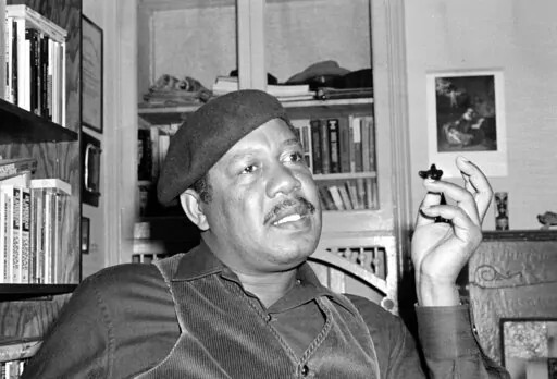 Novelist Ernest Gaines, who wrote "The Autobiography of Miss Jane Pittman," is pictured in his San Francisco home on April 12, 1977. Gaines, whose poor childhood on a small Louisiana plantation inspired stories of black struggles that grew into universal tales of grace and beauty, will be depicted on a U.S. postage stamp to be issued in January 2023. (AP Photo, File)