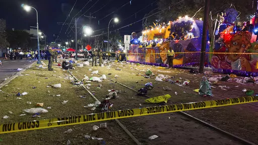 Police work the scene of a shooting at the Krewe of Bacchus parade on Sunday, Feb. 19, 2023. Five people were shot, including a young girl, during a Mardi Gras parade in New Orleans, police said, and a suspect was in custody. (David Grunfeld/The Times-Picayune/The New Orleans Advocate via AP)