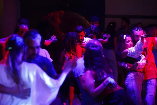 Couples dance at a dance club in Damascus, Syria, June 13, 2022. For the participants, ballroom dancing is a form of release, finding their rhythm in music away from their country’s many social and economic pressures. They push Syria's 11-year war from their minds, the politics, the anxiety over the economic crisis and the country's constantly depreciating currency. (AP Photo/Omar Sanadik)
