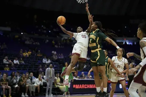 Florida State guard Ta'Niya Latson (00) shoots against George Mason forward Zahirah Walton (2) during the first half in the first round of the NCAA college basketball tournament, Saturday, March 22, 2025, in Baton Rouge, La. (AP Photo/Matthew Hinton)