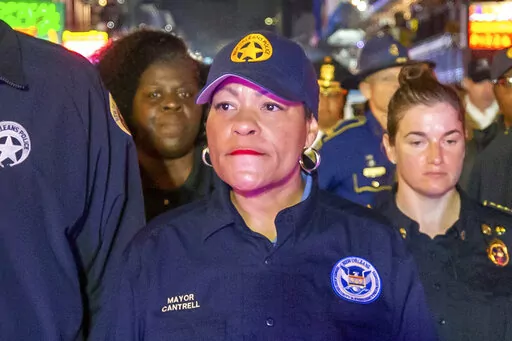 New Orleans Mayor LaToya Cantrell, center, along with other members of law enforcement, NOFD and EMS, walks down Bourbon Street just after midnight ceremoniously closing down Mardi Gras, Wednesday, Feb. 22, 2023, in New Orleans. Opponents of New Orleans Mayor LaToya Cantrell rushed 10 boxes of petitions into City Hall on Wednesday and declared they have enough enough signatures to force a recall of the second-term mayor. (David Grunfeld/The Times-Picayune/The New Orleans Advocate via AP)