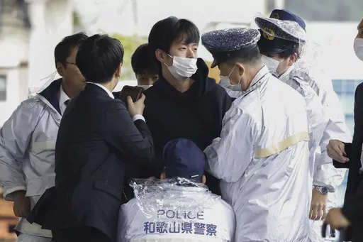 A man who was later identified as Ryuji Kimura is arrested after what appeared to be a pipe bomb was thrown at Japanese Prime Minister Fumio Kishida during his visit at a port in Wakayama, western Japan, Saturday, April 15, 2023. Kimura, who allegedly threw a pipe bomb at Kishida at a campaign venue, has complained about Japan’s election system and filed a damages suit against the government and criticized the prime minister, according to media reports and his possible social media postings. (