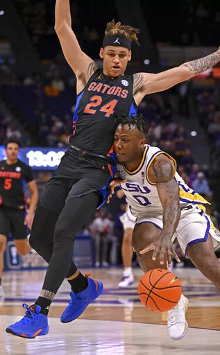 LSU guard Trae Hannibal (0) works to move past Florida guard Riley Kugel (24) during the first half of an NCAA college basketball game Tuesday, Jan. 10, 2023, in Baton Rouge, La. (Hilary Scheinuk/The Advocate via AP)