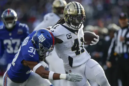 New Orleans Saints running back Alvin Kamara (41) carries the ball against New York Giants safety Tyler Nubin (31) during the second quarter of an NFL football game, Sunday, Dec. 8, 2024, in East Rutherford, N.J. (AP Photo/John Munson)