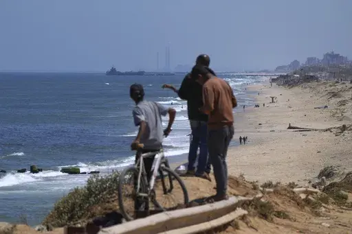 A ship is seen off the coast of Gaza near a U.S.-built floating pier that will be used to facilitate aid deliveries, as seen from the central Gaza Strip, Thursday, May 16, 2024. The pier built by the U.S. military to bring humanitarian aid to Gaza will be reinstalled Wednesday, July 10, 2024, to be used for several days, but then the plan is to pull it out permanently, several U.S. officials said. (AP Photo/Abdel Kareem Hana, File)