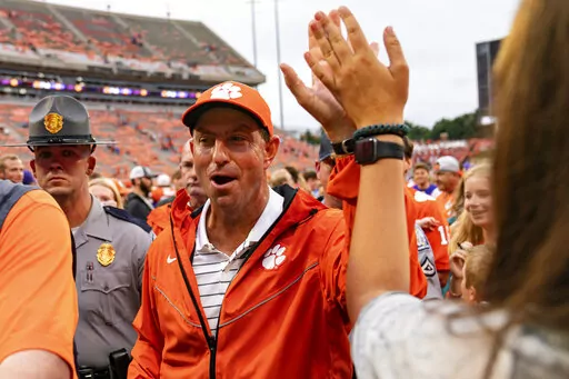Clemson Tigers head coach Dabo Swinney celebrates after defeating the Furman Paladins during an NCAA college football game in Clemson, S.C., Saturday, Sept. 10, 2022. (AP Photo/Jacob Kupferman)