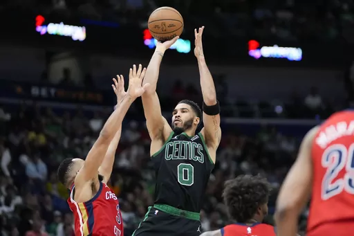 Boston Celtics forward Jayson Tatum (0) shoots against New Orleans Pelicans guard CJ McCollum in the second half of an NBA basketball game in New Orleans, Saturday, March 30, 2024. The Celtics won 104-92. (AP Photo/Gerald Herbert)