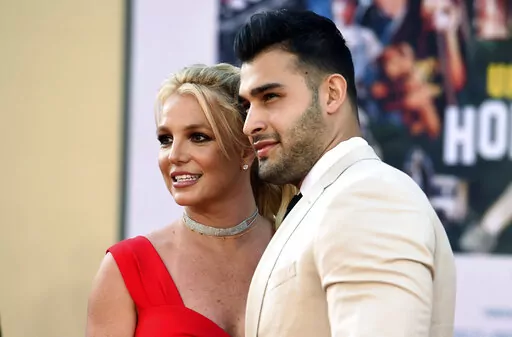 Britney Spears and Sam Asghari arrive at the Los Angeles premiere of "Once Upon a Time in Hollywood," at the TCL Chinese Theatre, Monday, July 22, 2019. Spears and her partner Asghari announced in a joint post on Instagram, Saturday, May 14, 2022, that they had lost their baby during pregnancy. The announcement came a little over a month after the couple revealed they were expecting a child. (Photo by Jordan Strauss/Invision/AP, File)