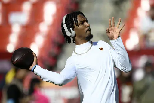 Washington Commanders quarterback Jayden Daniels warms up before an NFL football game against the Carolina Panthers, Sunday, Oct. 20, 2024, in Landover, Md. (AP Photo/Nick Wass)