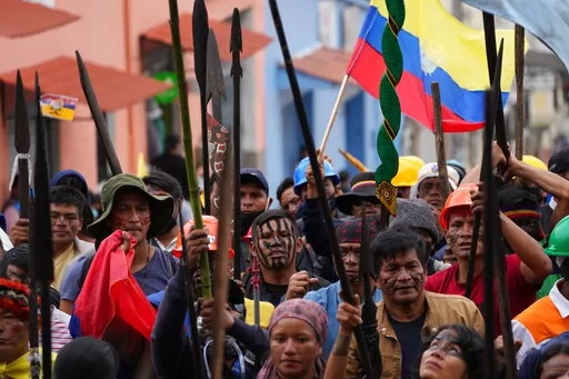 Indigenous protesters march to the Basilica del Voto Nacional where they expect dialogue with the government to take place in downtown Quito, Ecuador, Monday, June 27, 2022. Ecuadorian President Guillermo Lasso announced a cut in gasoline prices Sunday that fell short of the reduction demanded by Indigenous leaders to end a strike that has paralyzed parts of the country for two weeks. (AP Photo/Dolores Ochoa)