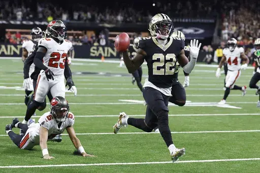 New Orleans Saints' Rashid Shaheed (22) gestures while returning a punt for a touchdown past Tampa Bay Buccaneers punter Jake Camarda (5) during the first half of an NFL football game in New Orleans, Sunday, Oct. 13, 2024. (AP Photo/Butch Dill)
