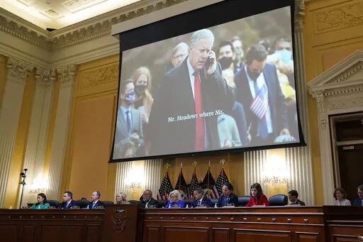 An image of former White House Chief of Staff Mark Meadows is shown as committee members from left to right, Rep. Stephanie Murphy, D-Fla., Rep. Pete Aguilar, D-Calif., Rep. Adam Schiff, D-Calif., Rep. Zoe Lofgren, D-Calif., Chairman Bennie Thompson, D-Miss., Vice Chair Liz Cheney, R-Wyo., Rep. Adam Kinzinger, R-Ill., Rep. Jamie Raskin, D-Md., and Rep. Elaine Luria, D-Va., look on, as the House select committee investigating the Jan. 6 attack on the U.S. Capitol holds its first public hearing to