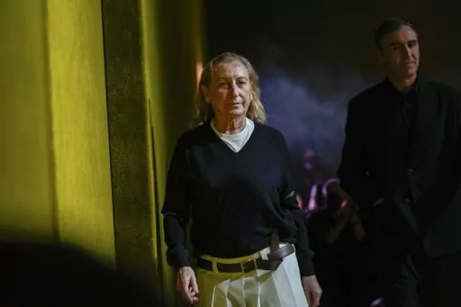 Miuccia Prada, left, and Raf Simons depart after the Prada Fall/Winter 2022-2023 fashion collection, unveiled during the Fashion Week in Milan, Italy, Thursday, Feb. 24, 2022. The Prada fashion house began charting a line of succession on its business side, announcing Tuesday, Dec. 6, 2022 that it is tapping a former LVMH executive as its next CEO, while confirming that Miuccia Prada will continue in her creative roles. Andrea Guerra is set to be confirmed by the board next month as the new CEO,