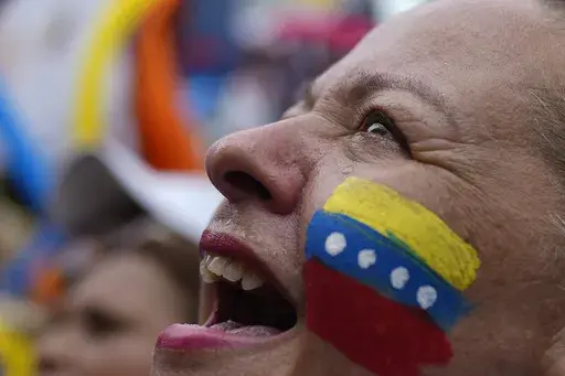 A supporter of opposition presidential candidate Edmundo Gonzalez cheers as thousnads wait for his arrival at a campaign rally in Barinas, Venezuela, Saturday, July 6, 2024. The official campaign period for the July 28 election kicked off on July 4. (AP Photo/Ariana Cubillos)