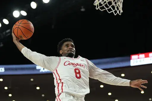 Houston guard Mylik Wilson (8) dunks the ball during the second half of an NCAA college basketball game against Louisiana Lafayette, Wednesday, Nov. 13, 2024, in Houston. (AP Photo/Kevin M. Cox)