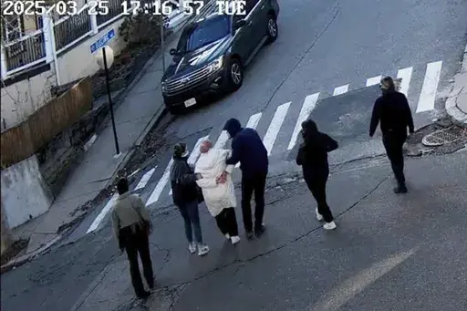CORRECTS DATE - In this image taken from security camera video, Rumeysa Ozturk, a 30-year-old doctoral student at Tufts University, is detained by Department of Homeland Security agents on a street in Sommerville, Mass., Tuesday, March 25, 2025. (AP Photo)