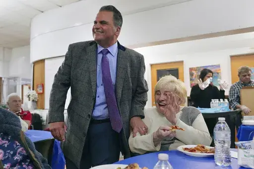 Everett, Mass. Mayor Carlo DeMaria smiles while visiting guests at a senior luncheon following a bingo game at the Connolly Center, Monday, Jan. 13, 2025, in Everett. (AP Photo/Charles Krupa)