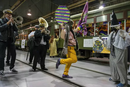 The Phunny Phorty Phellows (PPP) prepare to take their historic Twelfth Night streetcar ride to announce that Carnival has begun in New Orleans, Jan. 6, 2022. One year after the coronavirus pandemic forced a parade-free, quiet Mardi Gras in New Orleans, city officials touted preparations in place for a return to the big parades and festivities expected over the next two weeks ahead of Fat Tuesday.  (AP Photo/Kathleen Flynn)