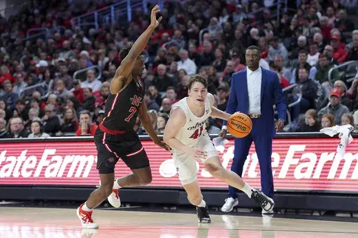 Cincinnati's Simas Lukosius drives to the basket a Nicholls State's Caleb Robinson defends during the first half of an NCAA college basketball game, Friday, Nov. 15, 2024, in Cincinnati. (AP Photo/Kareem Elgazzar)