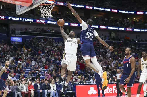 New Orleans Pelicans forward Zion Williamson (1) throws down a dunk on Los Angeles Clippers forward Derrick Jones Jr. (55) in the second half of an NBA basketball game in New Orleans, Tuesday, March 11, 2025. (AP Photo/Peter Forest)