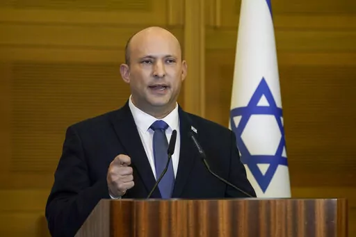 Israeli Prime Minister Naftali Bennett delivers a statement at the Knesset, Israel's parliament, in Jerusalem, Wednesday, June 29, 2022. Bennett will not run in upcoming elections, after he led a broad but fragile coalition government that came unraveled barely a year after taking office. (AP Photo/Tsafrir Abayov)