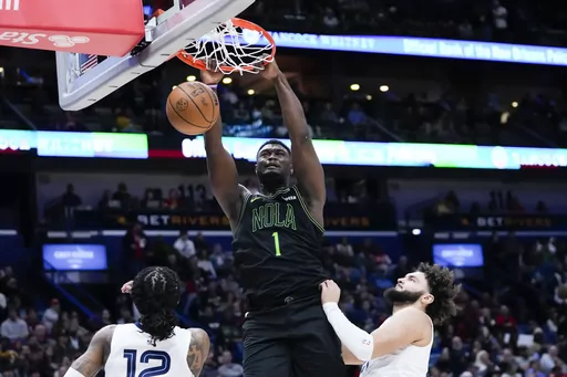New Orleans Pelicans forward Zion Williamson (1) slam dunks in the second half of an NBA basketball game against the Memphis Grizzlies in New Orleans, Tuesday, Dec. 19, 2023. The Grizzlies won 115-113. (AP Photo/Gerald Herbert)