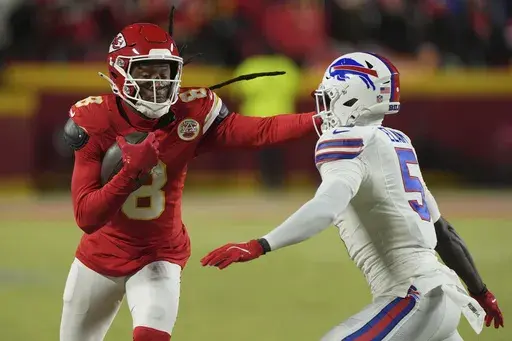 Kansas City Chiefs wide receiver DeAndre Hopkins (8) runs with the ball past Buffalo Bills cornerback Kaiir Elam (5) during the first half of the AFC Championship NFL football game, Sunday, Jan. 26, 2025, in Kansas City, Mo. (AP Photo/Charlie Riedel)