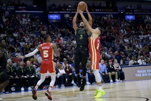 New Orleans Pelicans guard CJ McCollum (3) shoots against Atlanta Hawks guard Bogdan Bogdanovic, right, during the first half of an NBA basketball game in New Orleans, Saturday, Nov. 4, 2023. (AP Photo/Matthew Hinton)