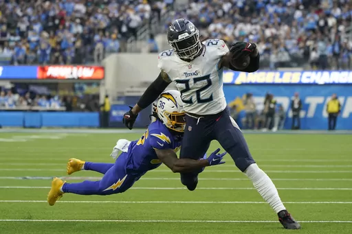 Tennessee Titans running back Derrick Henry (22) runs against Los Angeles Chargers cornerback Ja'Sir Taylor (36) during the first half of an NFL football game in Inglewood, Calif., Sunday, Dec. 18, 2022. Henry is perhaps the best dominant runner in the game with more than 1,500 yards on the ground in three of the past four seasons. (AP Photo/Marcio Jose Sanchez, File)