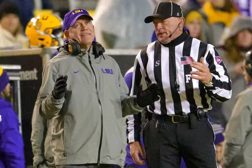 LSU coach Brian Kelly listens to an official on sideline during the second half the team's NCAA college football game against UAB in Baton Rouge, La., Saturday, Nov. 19, 2022. (AP Photo/Matthew Hinton)